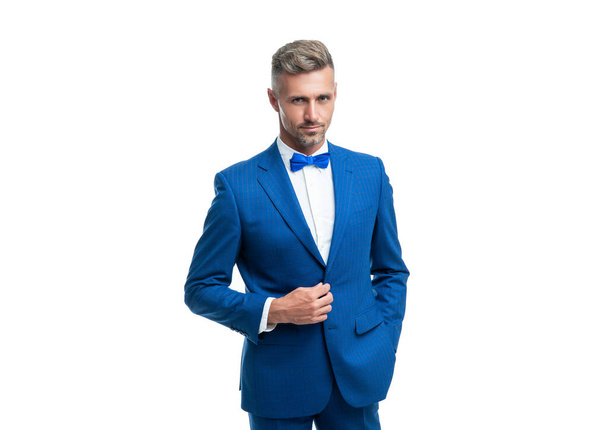 ambitious businessman in blue tuxedo suit with neck bow isolated on white background. - Foto, afbeelding