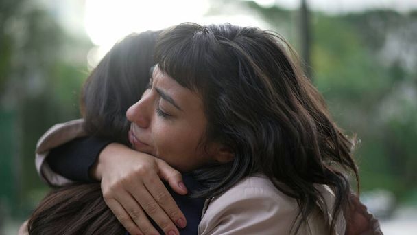 Sympathetic woman hugging friend with EMPATHY and SUPPORT. Friendship concept between two best friends - Photo, Image
