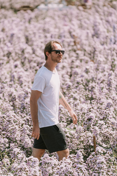 A man walking in flower field. High quality photo - Fotoğraf, Görsel
