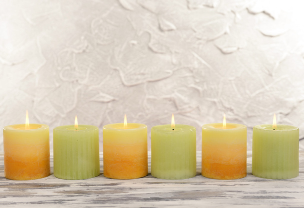 Beautiful candles on table on grey background - Foto, afbeelding