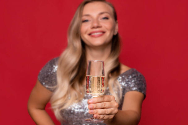 Party cheer. Happy woman day. Festive celebration. Elegant female hand red holding glass of champagne. - Foto, Imagem