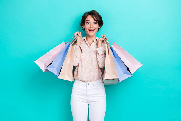 Photo of cheerful charming person arms hold shop packages isolated on emerald color background. - Photo, Image