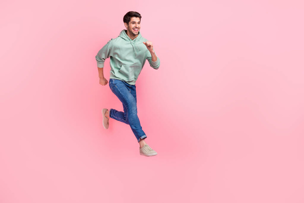 Full length photo of funky good mood man boy wear stylish outfit run empty space cool offer proposition isolated on pink color background. - Photo, image