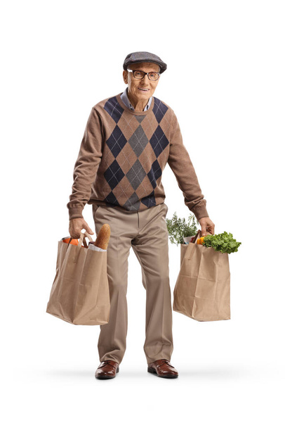 Tired elderly man carrying two grocery bags isolated on  white background - Φωτογραφία, εικόνα
