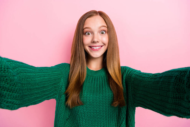 Photo of excited adorable girl dressed knitted pullover recording self video smiling isolated pink color background. - Foto, imagen