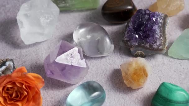 various semi-precious gem stones on a wooden table slow motion - Footage, Video