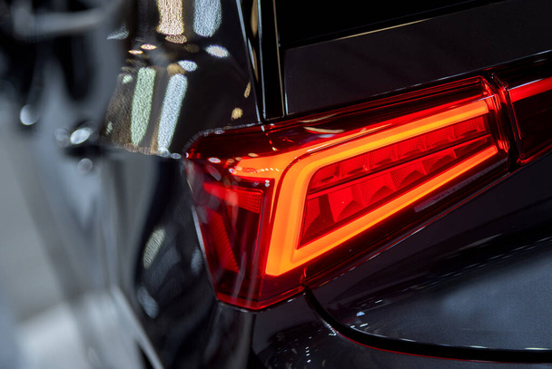 Luxury car red tail light on a dark brurred background.  - Valokuva, kuva