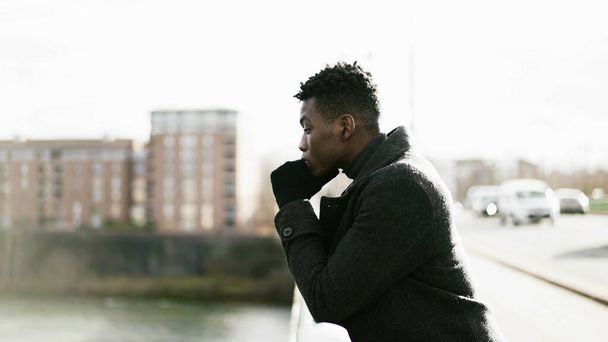 Elegant Contemplative African man looking at horizon wearing winter clothes - Foto, Imagem