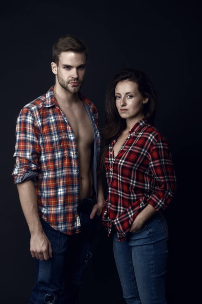 Family look. Similar outfits. Couple wear checkered shirts. Rustic hipster style. Handsome man and woman looking similar in family style clothes. Casual and comfortable. Family posing photo session. - Φωτογραφία, εικόνα
