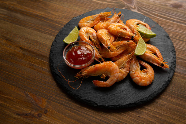 Top view of snack prawn and dip lime slices on wooden background - Fotografie, Obrázek