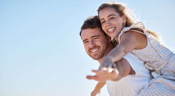 Love, blue sky and happy couple together for summer, holiday and outdoor wellness, date anniversary and freedom with mockup. Happy woman and man piggyback ride for support, care and healthy lifestyle. - Valokuva, kuva