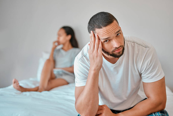 Couple, divorce and stress in home bedroom, fighting or argument. Portrait, anxiety and unhappy man and woman, sad and depressed after infidelity, toxic relationship or failed marriage in house - Fotó, kép