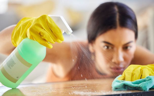 Spray bottle, cloth and woman cleaning table from bacteria, germs or dirt with disinfectant liquid. Housekeeping, hygiene and maid or cleaner with chemical to wipe dust on furniture in home or office. - Φωτογραφία, εικόνα