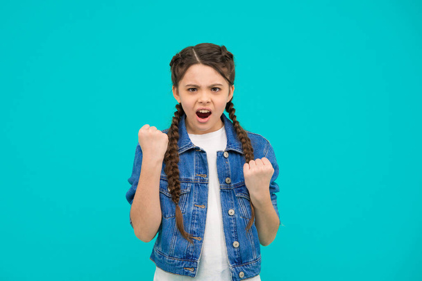 Lost her temper. Bad girl. Angry kid shake fists blue background. Bad behavior. Aggression and negativity. Anger and annoyance. Naughty and terrible. - Фото, зображення