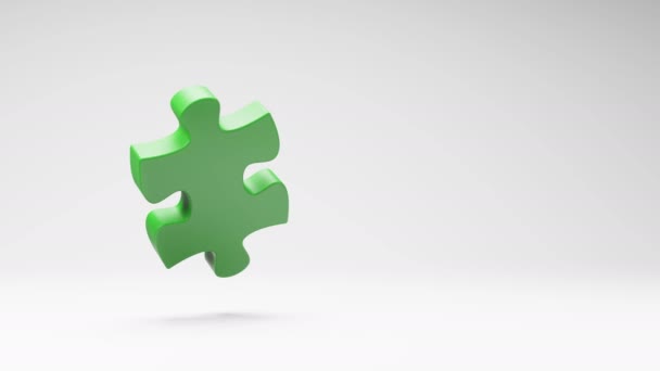 One Green Puzzle Piece Spinning on a Studio Light Gray Background, Seamless Loop 3D Animation with Copy Space - Footage, Video