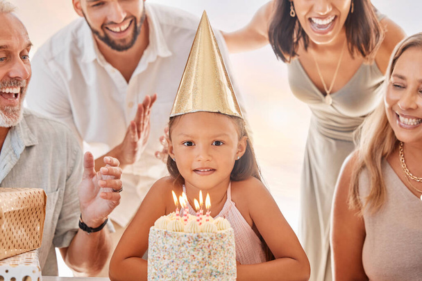 Birthday, candles on birthday cake and child with big family celebrate party event, sing together and show girl love in apartment home. Happy mother, father and child bonding with grandparents smile. - Foto, imagen