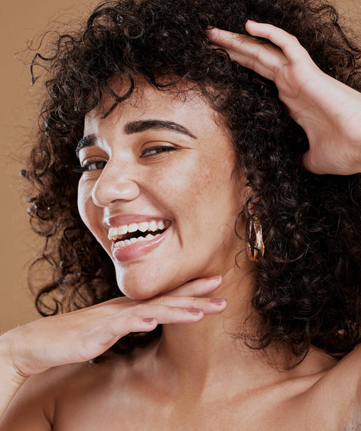 Portrait, woman and face makeup, happy and skincare with beauty, smile and happy in brown studio background. Hair care, afro or curls with healthy skin, glow and happiness model with facial cosmetic. - Фото, зображення