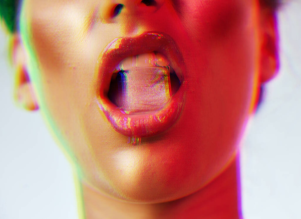 Woman, beauty and ice cube in mouth for makeup, cosmetics and neon lights background. Sexy woman with red lips in studio for fashion grunge aesthetic, frozen water and luxury for vaporwave mockup. - Foto, Bild
