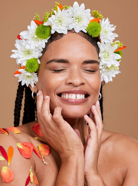 Beauty, skincare and flowers in hair of black woman for natural, spring and self love. Happy, salon and luxury with face of girl model for cosmetics facial, makeup and product in studio background. - Foto, Imagem