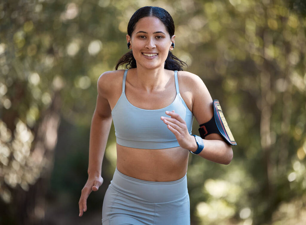 Fitness, woman and running portrait, exercise and training for marathon, cardio and smile in park or forest. Runner, workout and motivation run, happy and healthy lifestyle and body wellness nature. - Photo, image