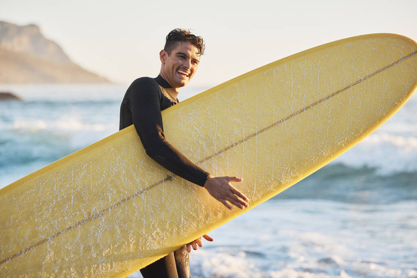 Portrait, man and surfing board, beach and summer training, freedom and happiness outdoors in South Africa. Portrait of happy surfer guy, ocean and sea water, relax and happiness for nature adventure. - 写真・画像