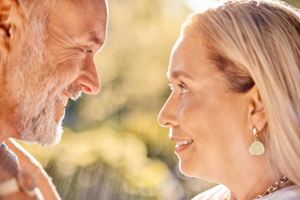 Mature, couple and face for bonding, love and care romantic relationship in a summer garden. Old man and woman in love in retirement for bond, caring and honeymoon affection in a park in spring. - Photo, Image