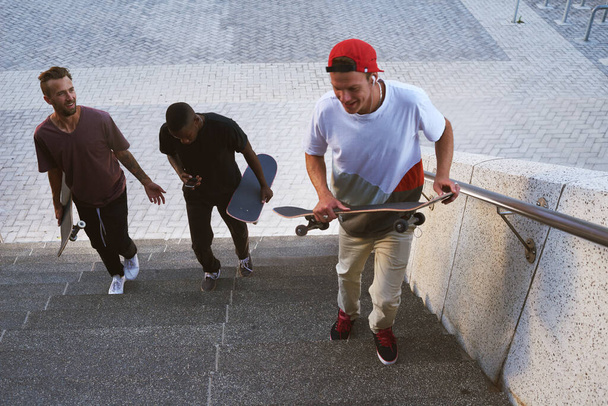 Skateboarding, making people happy since the 1950s. a group of skaters walking together - Foto, imagen
