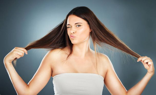Hair care, beauty and woman with hair in hands for wellness, beauty salon and cosmetics. Hair salon, style and portrait of girl advertising growth for natural, healthy and long hair after treatment. - 写真・画像