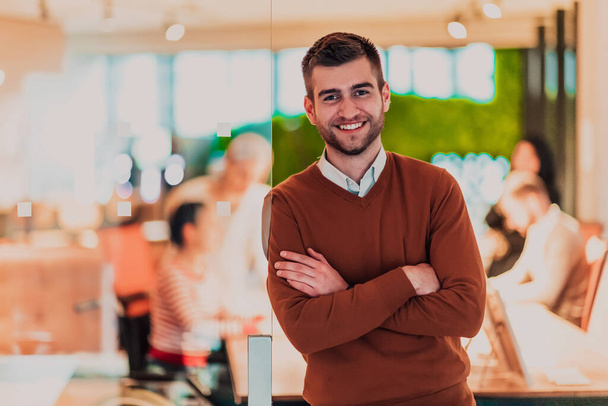 Handsome young businessman standing confident in the office in front of his team. High quality photo - Фото, изображение