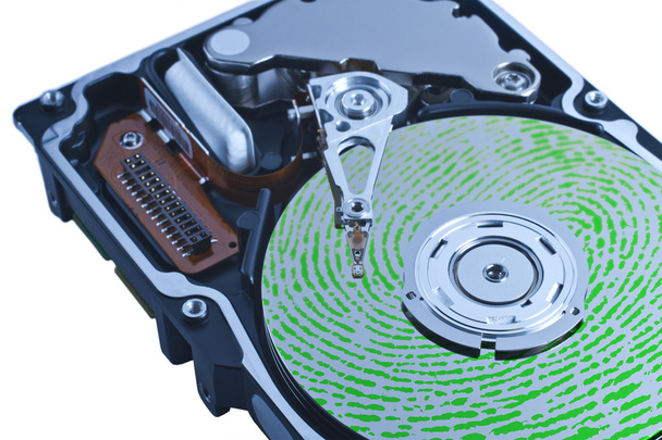 Open hard drive with green fingerprint on platter - Photo, Image