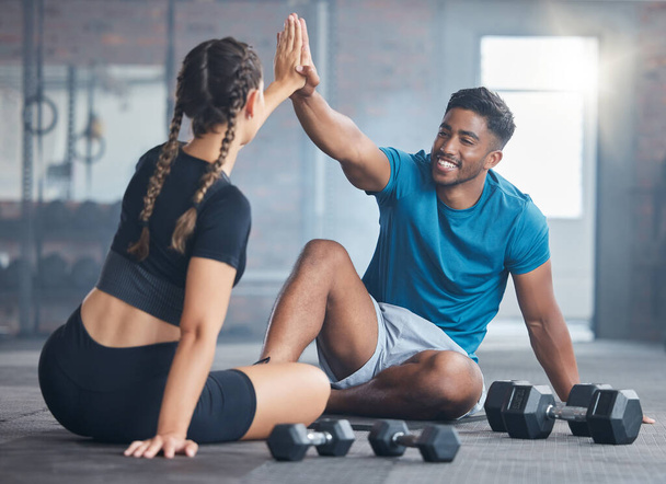 Fitness couple, high five and personal trainer with woman client to celebrate achievement, success and goal after exercise. Man and woman together at gym for partnership, health and wellness workout. - Fotó, kép