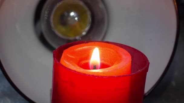 Burning candle on the background of a table lamp. Blackout in Ukraine due to war - Footage, Video