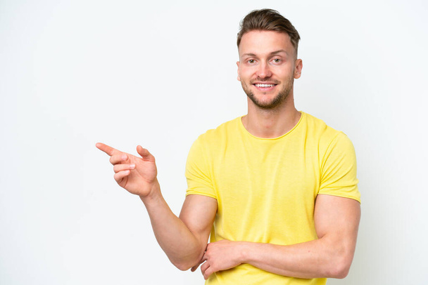 Young blonde caucasian man isolated on white background pointing finger to the side - Foto, Imagen