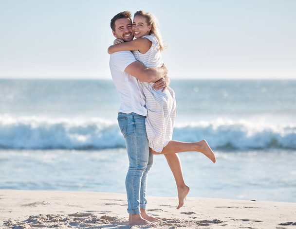 Hug, happy and couple at the beach for love, peace and relax on a tropical holiday in Hawaii. Freedom, travel and portrait of a man and woman hugging by the ocean excited about a vacation in summer. - Foto, afbeelding