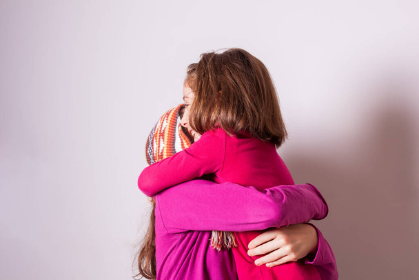 Happy and healthy young little girls hugging and smiling. Best friend kids and children friendship, equality, positive mental health wellness concept - Photo, Image