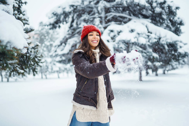 Happy woman  enjoying first snow in the forest. Holidays, rest, travel concept - 写真・画像