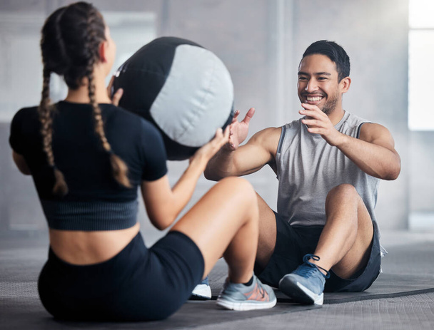 Fitness, ball and couple doing an exercise together for health, wellness and strength in the gym. Sports, healthy and strong man and woman athletes doing a workout or training in a sport center - Fotó, kép