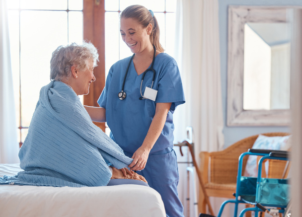 Retirement, healthcare and old woman with nurse in bedroom for support, rehabilitation and disability. Help, medical and consulting with caregiver and elderly patient in nursing home for therapy. - Photo, image