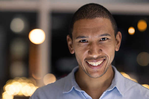 Business man portrait, smile and corporate worker ready for financial and accounting work at night. Company vision and happiness of a black man smile about finance growth in a modern office. - Foto, Imagem
