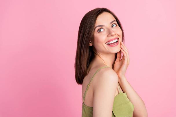Photo of adorable gorgeous positive woman with brunette hairstyle palm on cheekbone look empty space isolated on pink color background. - Φωτογραφία, εικόνα