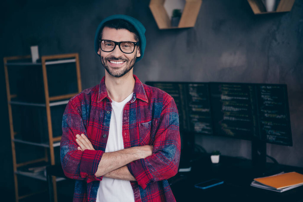Photo of positive smiling programmer wear spectacles having work done arms folded indoors workplace workshop home. - Foto, afbeelding