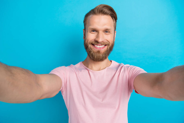 Photo portrait of nice young man toothy beaming smile take selfie front camera wear trendy pink clothes isolated on cyan color background. - Foto, Imagem