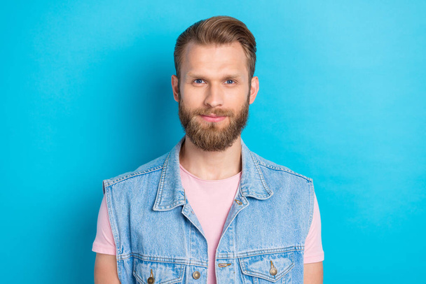 Photo of good mood funky young man wear jeans waistcoat smiling isolated blue color background. - Foto, immagini
