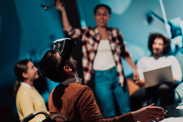 Business persons with a disability at work in modern open space coworking offices on team meetings using virtual reality goggles. High quality photo - Photo, Image