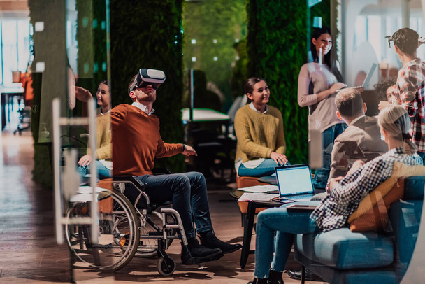 Business persons with a disability at work in modern open space coworking offices on team meetings using virtual reality goggles. High quality photo - 写真・画像