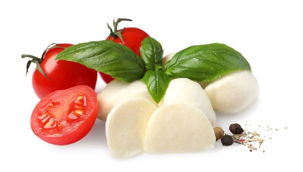 Delicious mozzarella with tomatoes and basil leaves on white background - Foto, Imagem