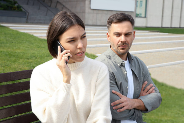 Woman ignoring her boyfriend and talking on phone. Relationship problems - Photo, image