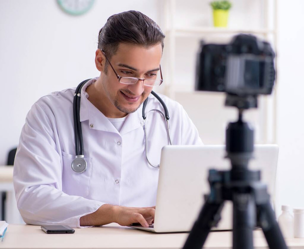 The young male doctor recording video for his blog - Foto, Imagem