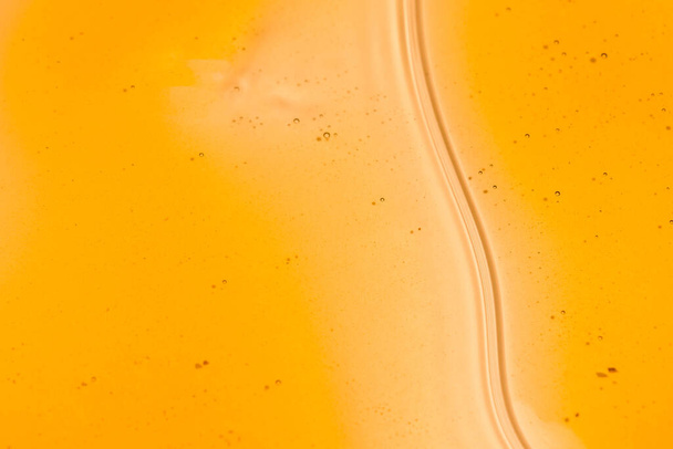 Sweet honey flowing on white background. Honey liquid texture. Healthy food concept. Selective focus. - Foto, Imagen