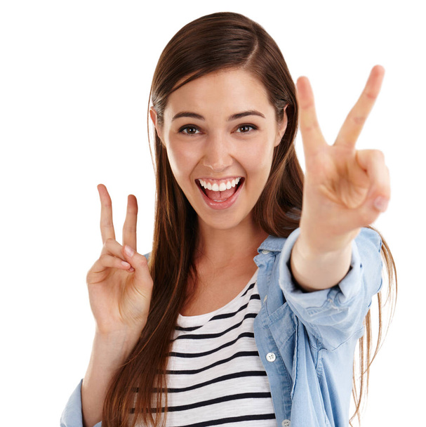 Bring the peace. Studio shot of a beautiful young woman giving you the peace sign against a white background - Foto, imagen